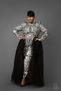 a woman in a black and white dress posing for a photo