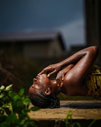 a woman is laying on the ground doing yoga